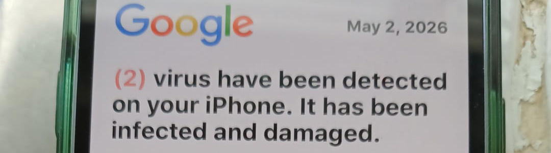 Photo of an iPhone displaying a message that claims a virus has infected the phone